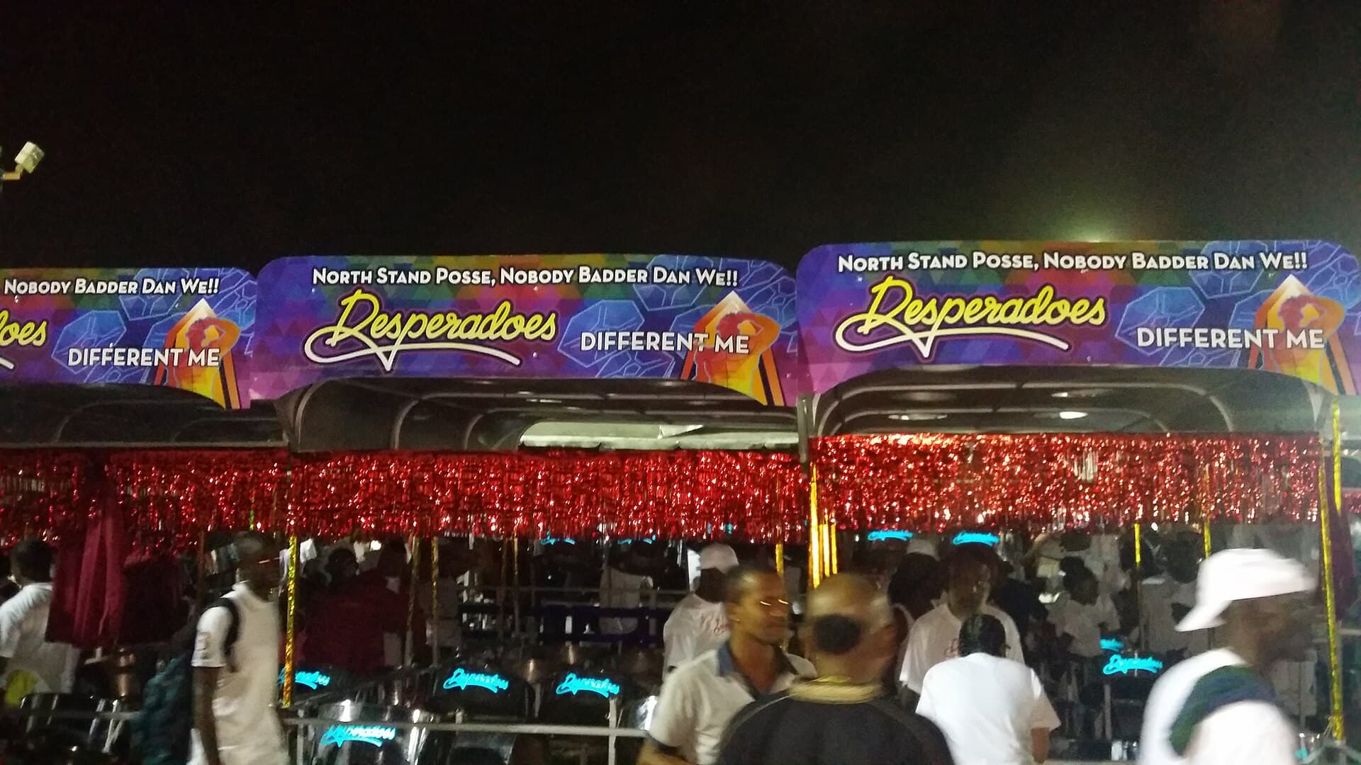 Desperadoes Steel Orchestra's pan racks, under banners reading Different Me, at a night rehearsal on the Queen's Park Savannah before the 2016 Panorama finals